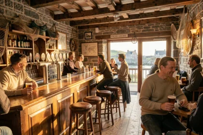Intérieur animé d'un bar breton traditionnel avec murs en granit, comptoir en bois et décoration nautique, symbolisant l'ambiance des meilleurs bars de Bretagne